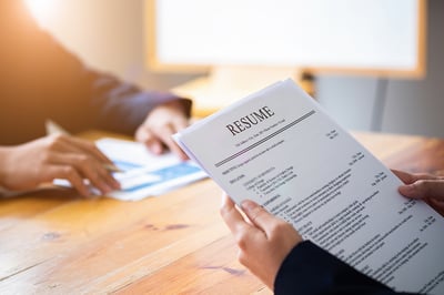 bigstock-Interviewer-Reading-A-Resume--310333042-sm