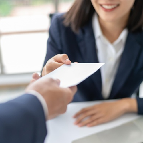 man handing resume to employer