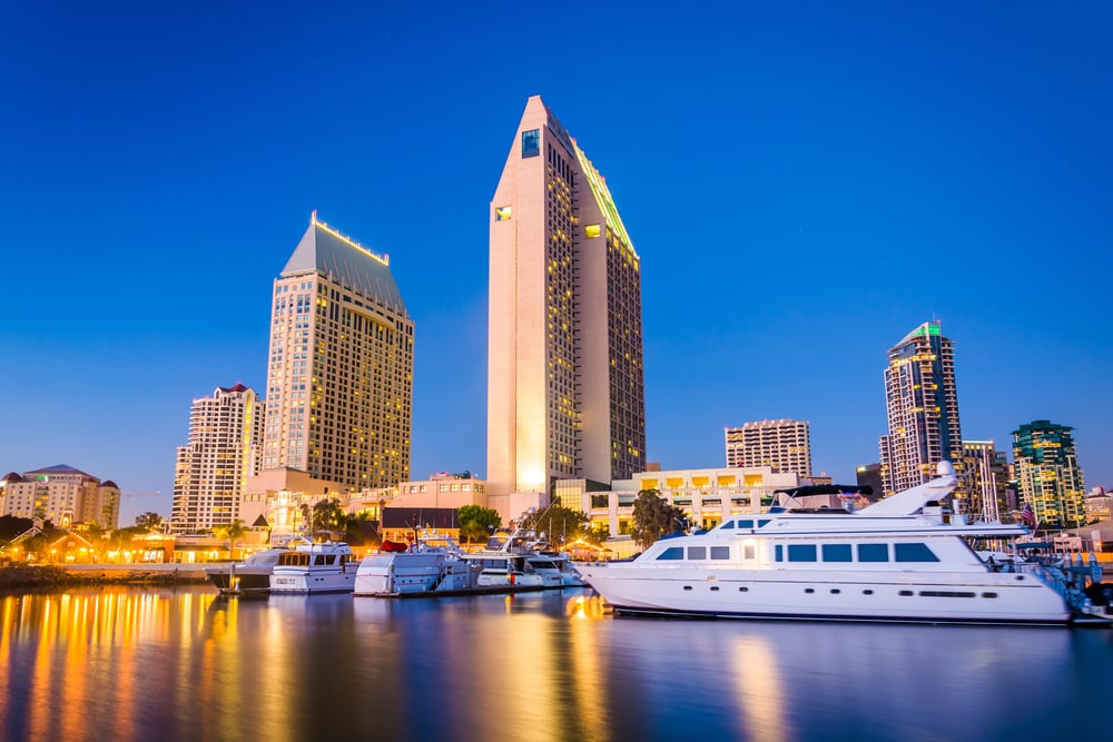 The San Diego skyline and boats at night, seen from Embarcadero Marina Park North, in San Diego, California.